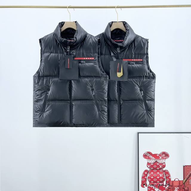 Prada 普拉达经典24Fw 红色硅胶饰条羽绒马甲 Prada的经典爆款马甲羽绒服最值得入手 此款廓形丰满的羽绒外套采用 Prada Linea rossa独